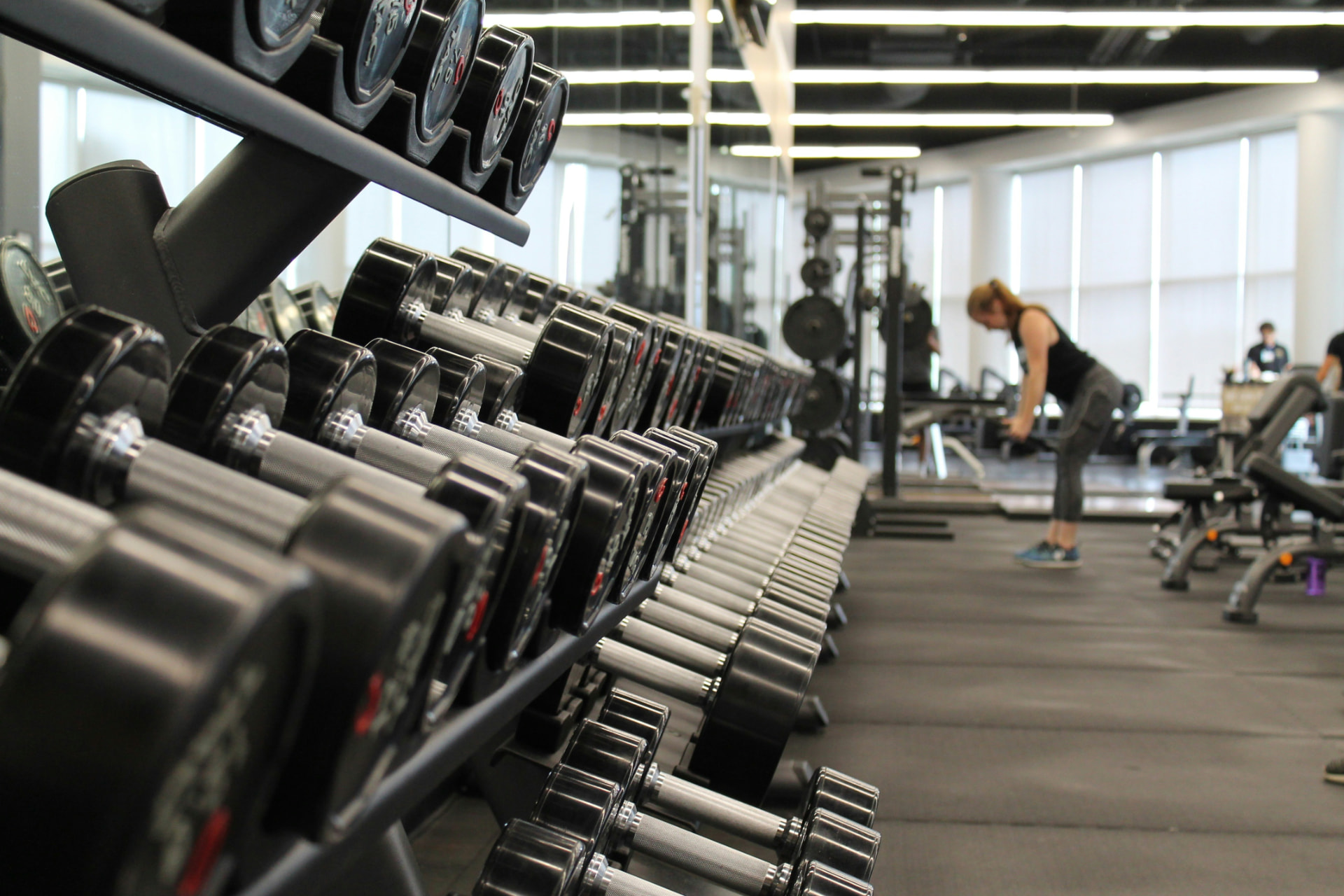 Dumbbell rack in a bright commercial gym floor