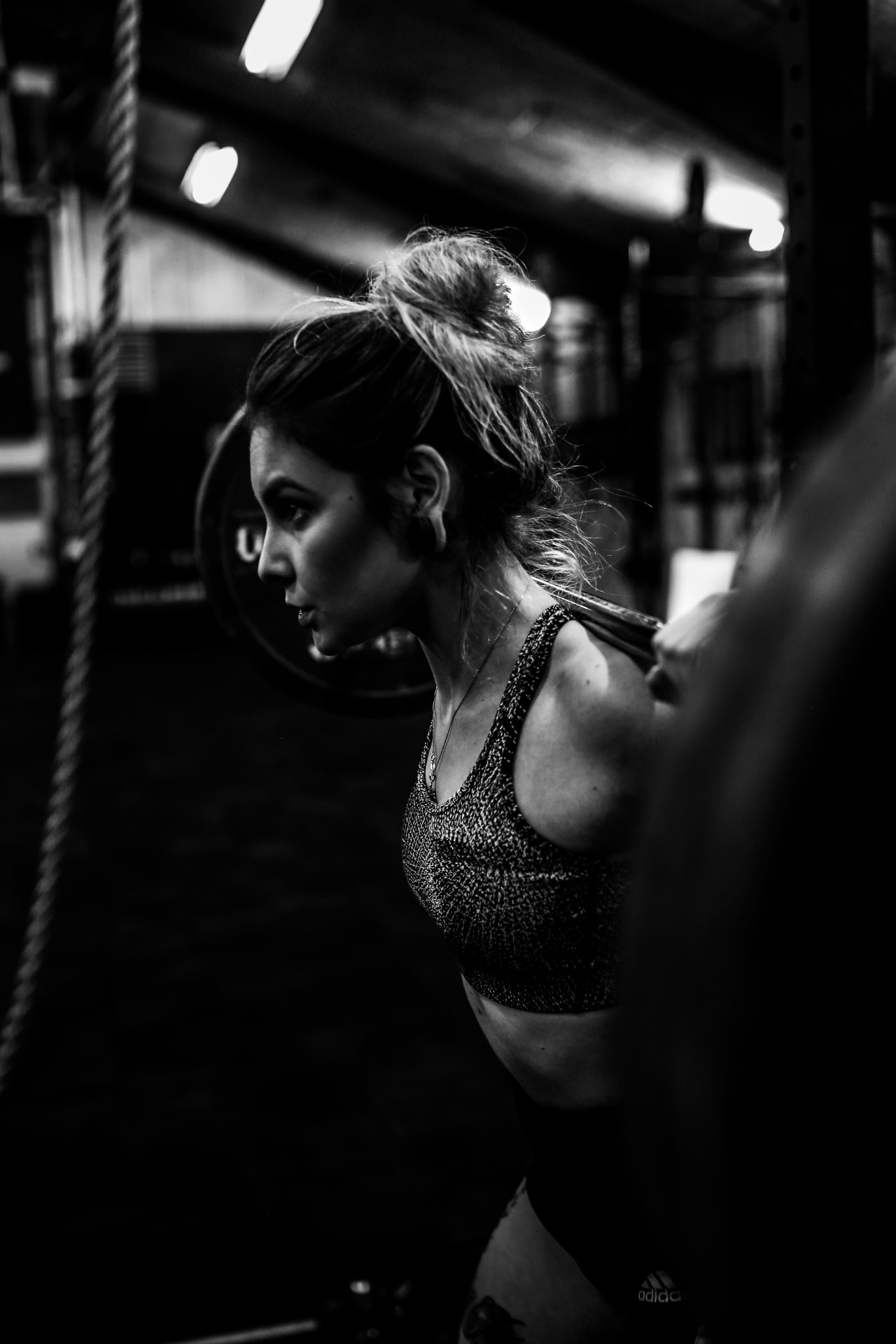 Athlete under a loaded barbell in a strength gym
